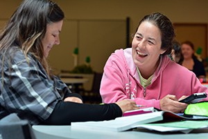 Campus_Student_with_Calculator_Laughing_with_Other_Student