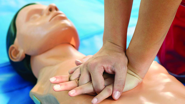 student practicing CPR on a dummy