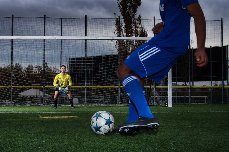 A player kicks a soccer ball