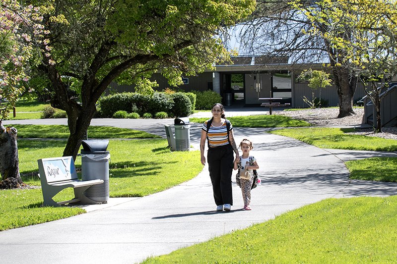student on campus with child