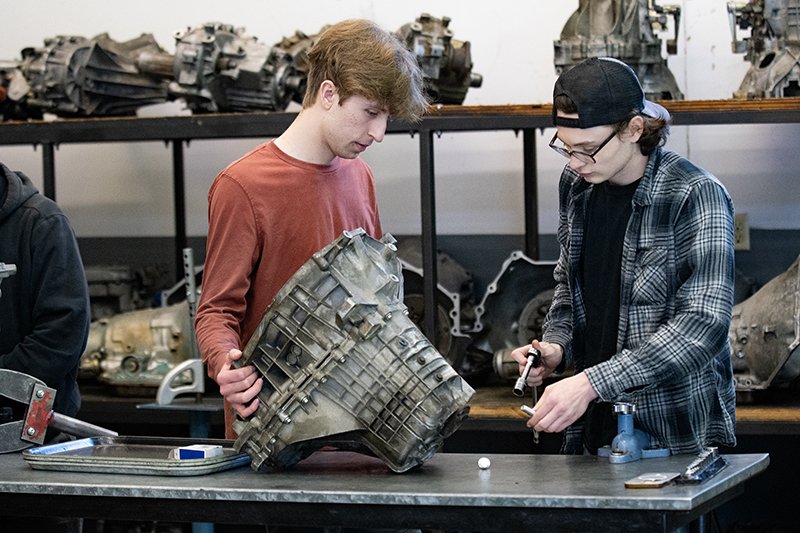 students working on an engine