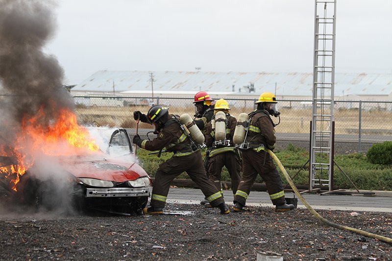 firefighters burning car