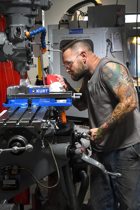 student working at manufacturing facility