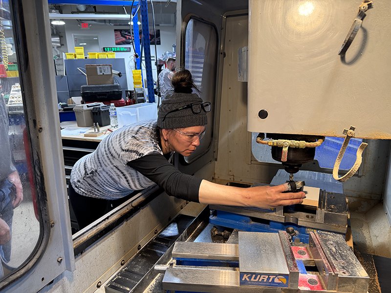 Woman working on a manufacturing machine