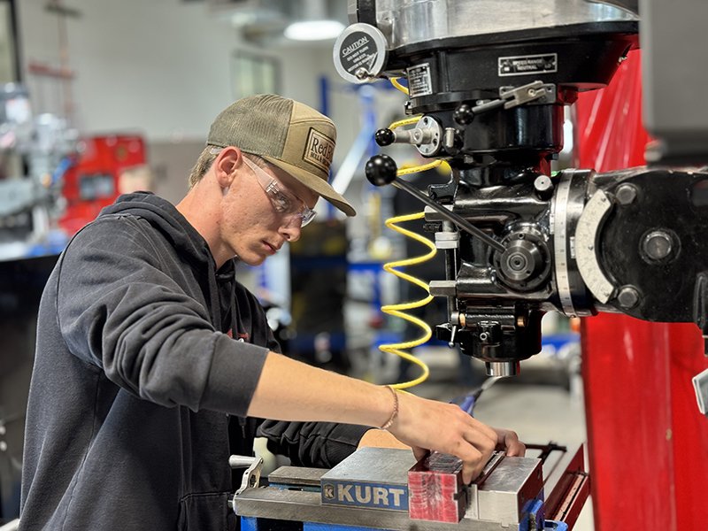 student using manufacturing equipment