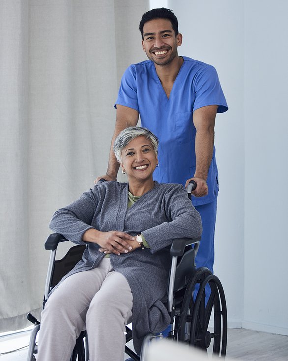medical assistant pushing wheelchair