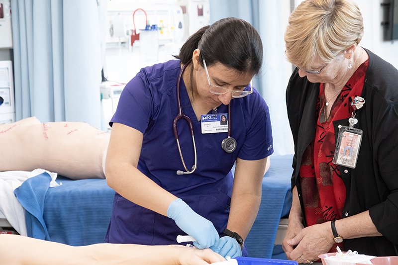 practical nursing student with instructor