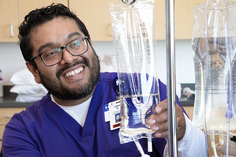 practical nursing student with IV bags