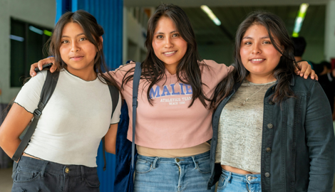 Latina students in a hallway of a school