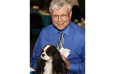 steve roe, citizen of the year, poses with his dog