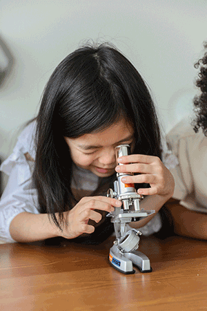 child with microscope