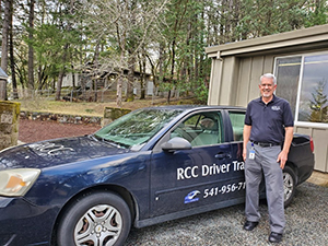RCC Driver Ed instructor in front of a training car