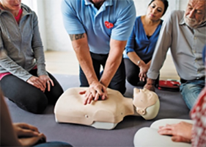 a class member performing cpr on a dummy
